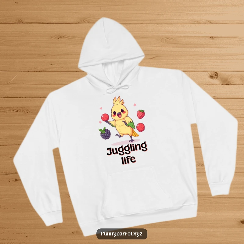 Funny parrot hoodie featuring a playful bird juggling three colorful berries with impressive dexterity.